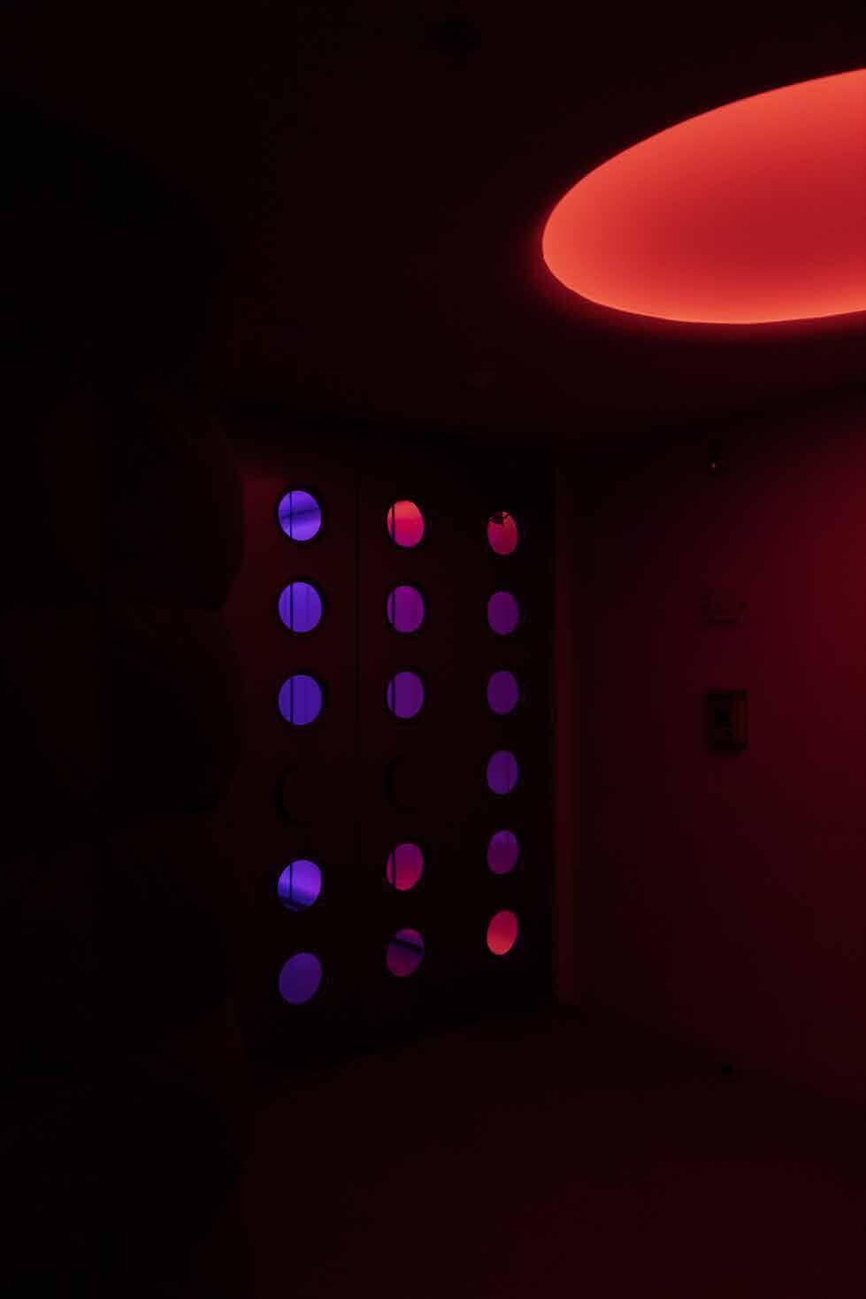 Wall of illuminated circular openings at Hi Im Sci