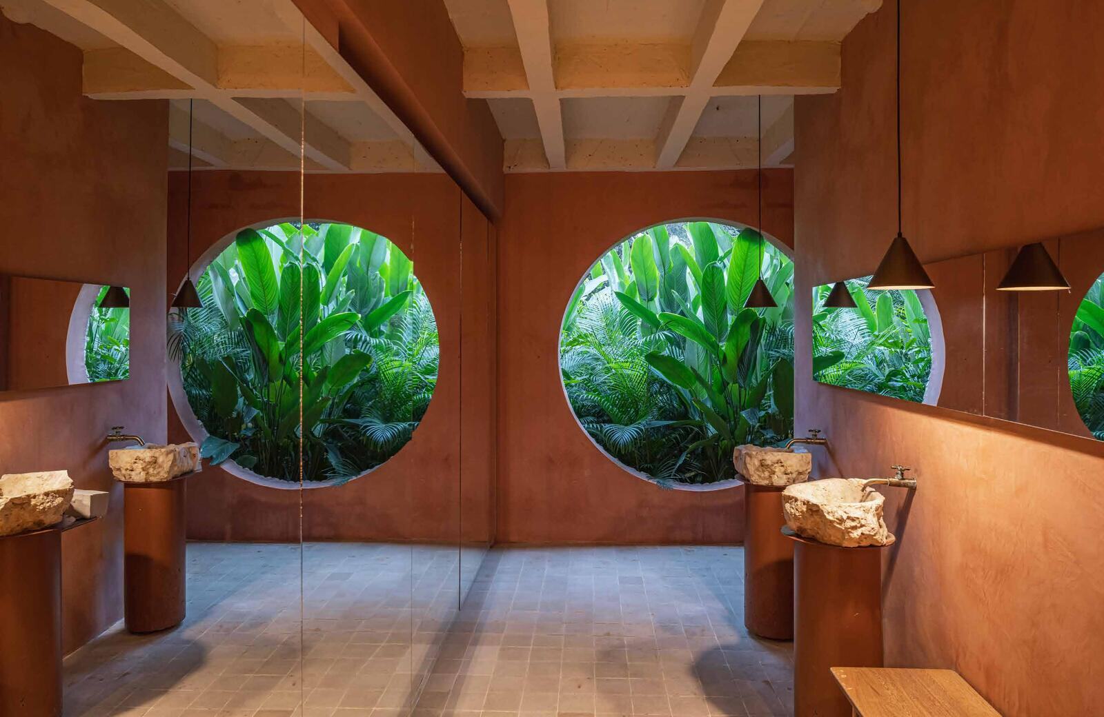 Wet area at Arde La Selva with circular windows to the jungle